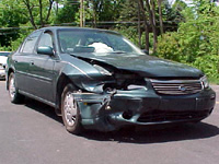 This green Chevy Malibu needed body work after a front-end collision.